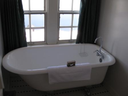 a bathtub with a towel from the window
