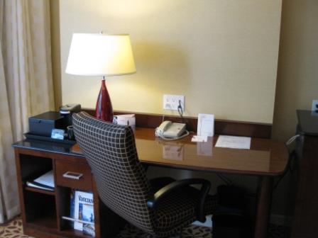 a desk with a lamp and a telephone