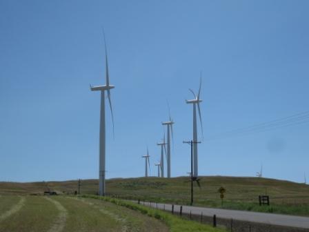 a wind turbines on a hill with Codrington Wind Farm in the background