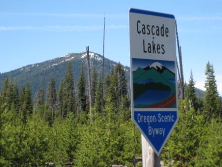 a sign with mountains in the background