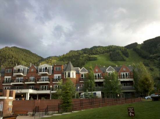 a building with balconies and trees on a hill