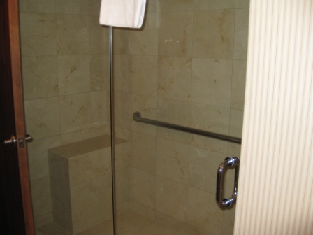 a glass shower door with a towel from the door