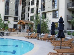 a pool with lounge chairs and umbrellas