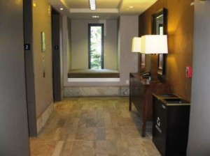 a hallway with a lamp and a mirror