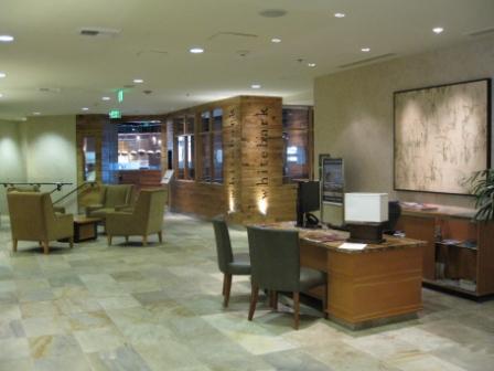 a lobby with a computer desk and chairs