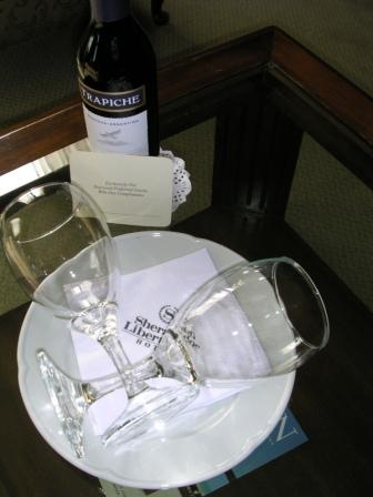 a wine bottle and two wine glasses on a plate