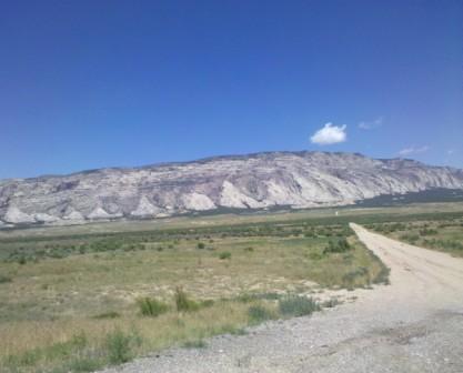 a dirt road leading to a mountain