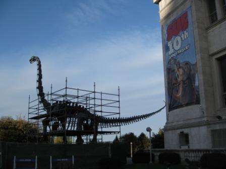 a dinosaur statue under scaffolding