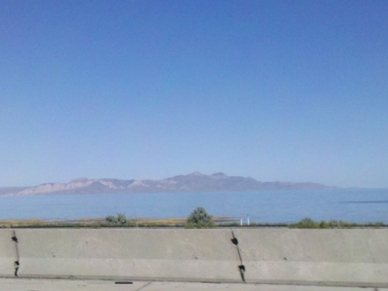 a concrete wall with a body of water in the background