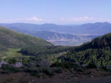 a view of a valley with mountains in the background