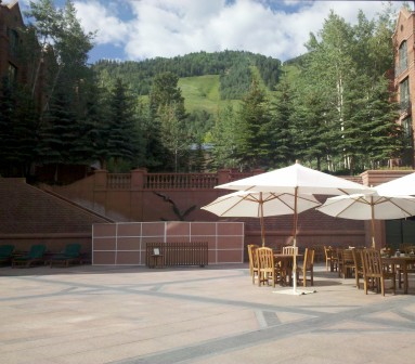 a patio with chairs and umbrellas