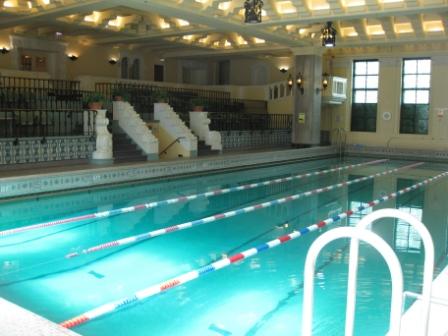 a swimming pool with stairs and railings