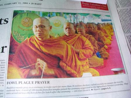 a newspaper with a group of men in orange robes