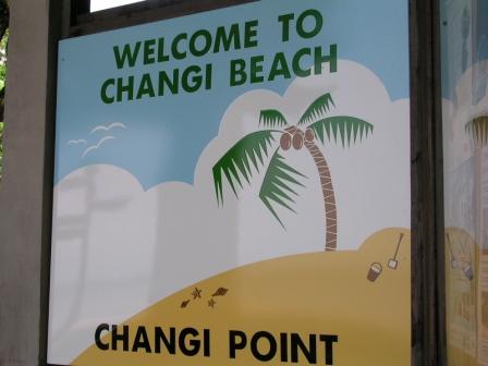 a sign with palm trees and clouds