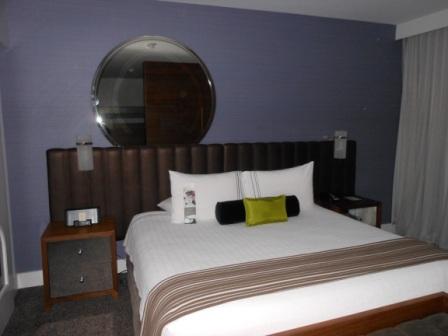 a bed with a round mirror