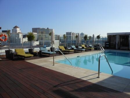 a pool with lounge chairs and a deck