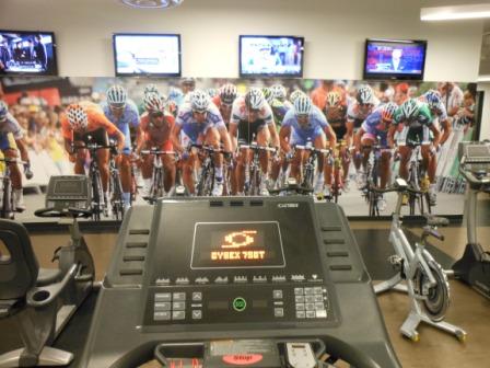 a treadmill with a picture of cyclists in the background