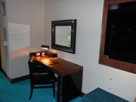 a desk in a room with a tv