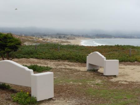 a white benches in a grassy area