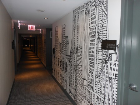 a long hallway with a drawing of buildings