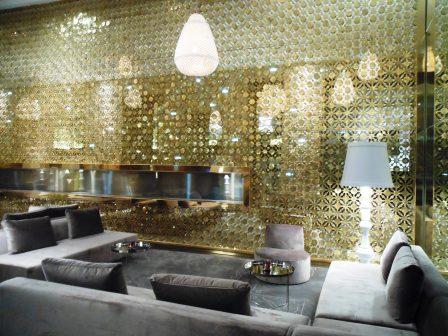 a room with a gold wall and a couch