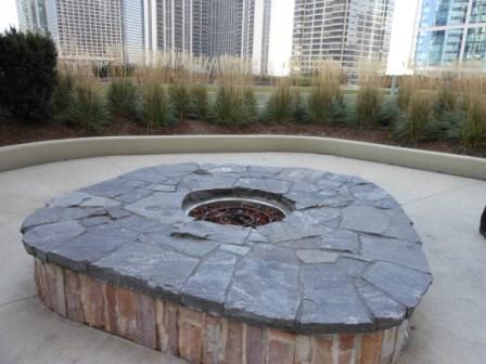 a stone fire pit in a courtyard