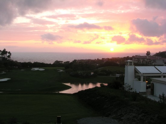 a sunset over a golf course