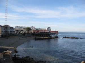 a beach with buildings and a body of water