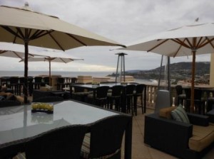 a patio with chairs and umbrellas