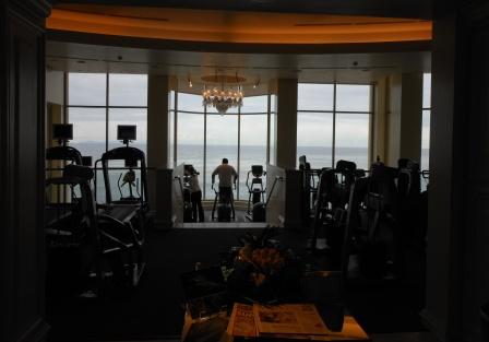 a room with a large window and a man on treadmills