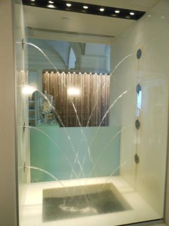 a glass shower with water splashing