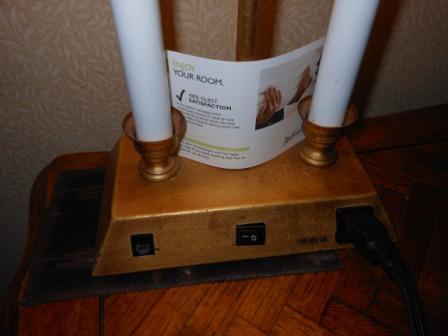 a lit candle holder with a plug