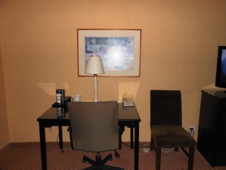 a desk and chair in a hotel room