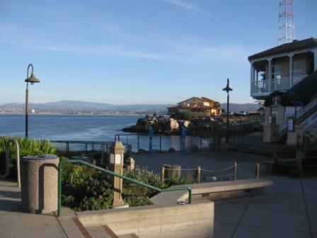 a view of a waterfront with a building and a fence