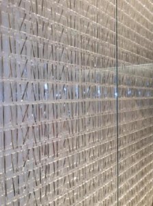 a glass wall with a pattern of sticks