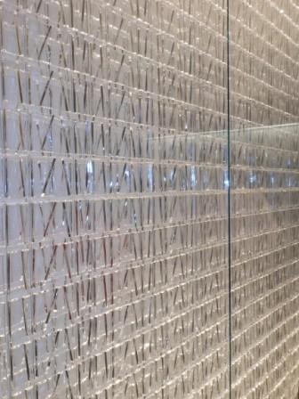 a glass wall with a pattern of sticks