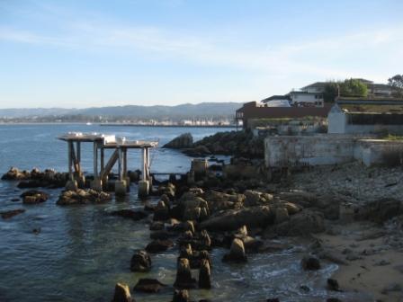 a rocky shore with a pier