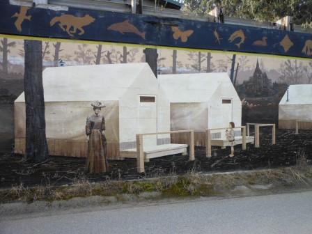 a mural of a woman and a child in a camp