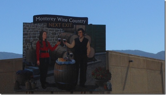 a sign with a couple of people holding wine glasses
