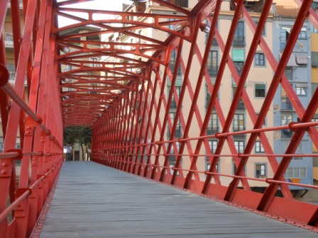 a red bridge with a wooden walkway