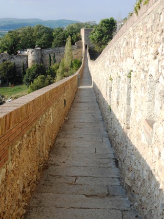 a stone wall with a long walkway