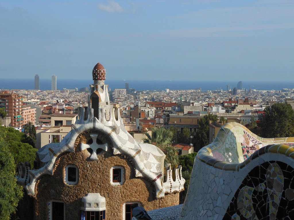 a building with a mosaic roof and a city in the background