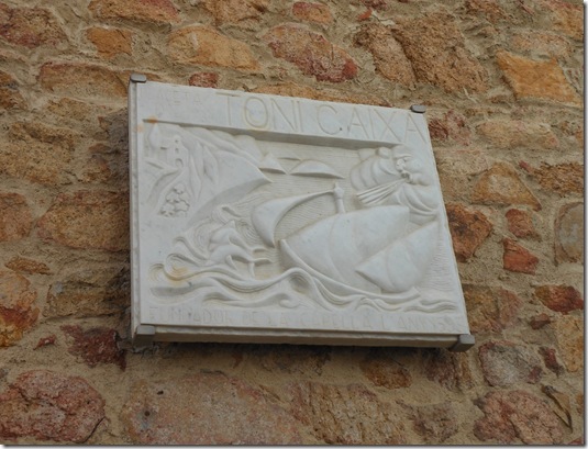 a stone plaque with a picture of a boat on it