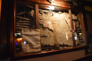 a display case with a broken wall