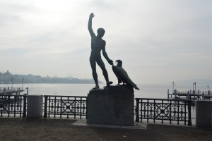 a statue of a man holding a bird