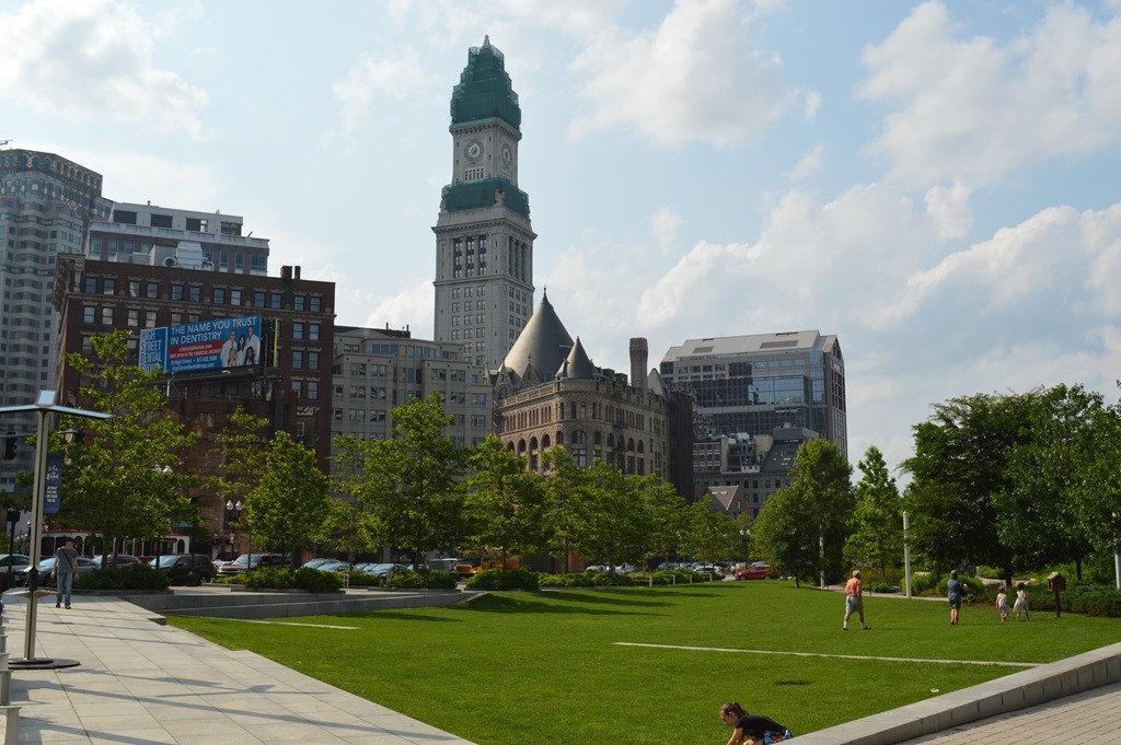 a park with a large clock tower in the background