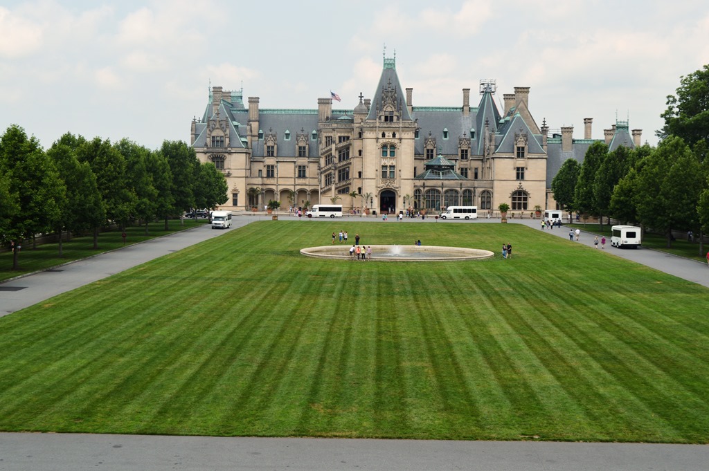 a large building with a fountain in front of it with Biltmore Estate in the background