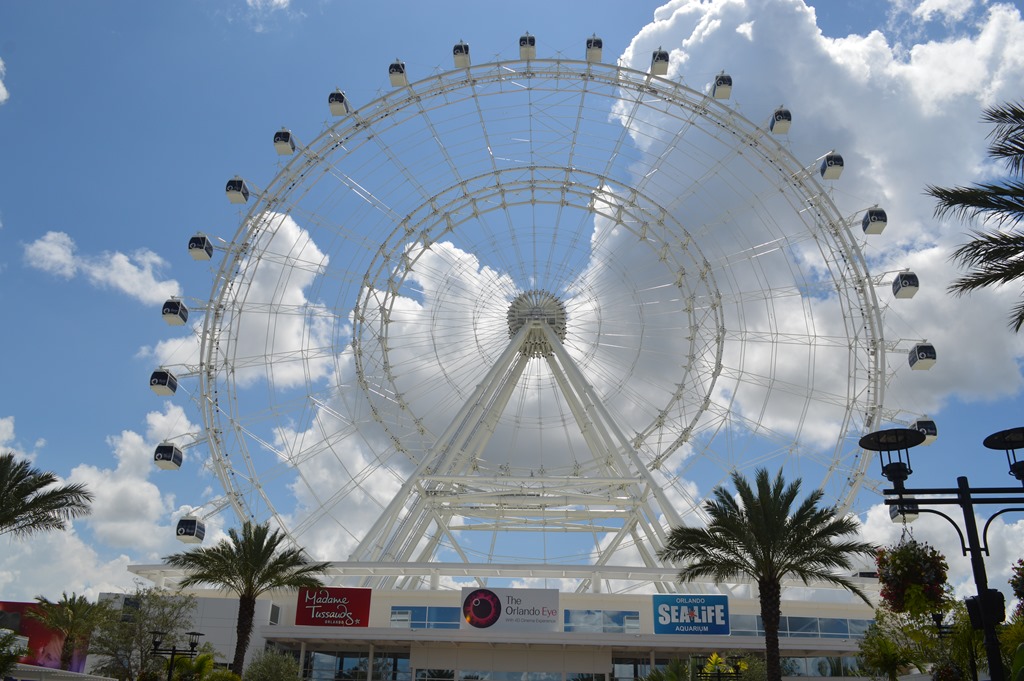 a ferris wheel with clouds in the sky