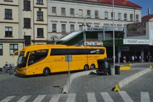 a yellow bus parked in front of a building