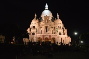 a large building with a dome at night with Sacré-Cœur, Paris in the background